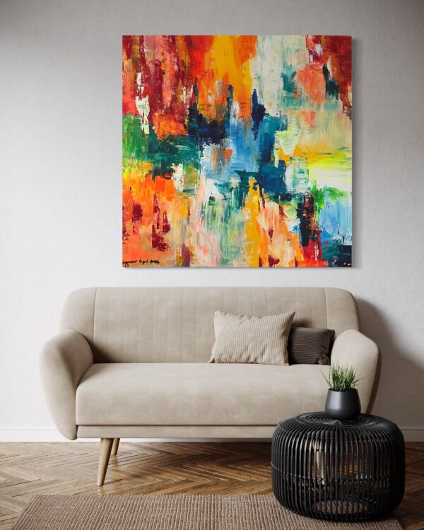 A couch and coffee table in front of a painting.
