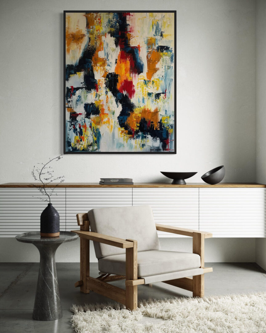 A white chair and table in front of a painting.