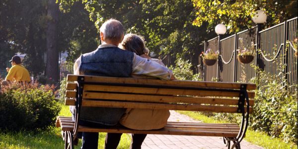 cr=w_600,h_300 (1) Elderly couple embracing on park bench.