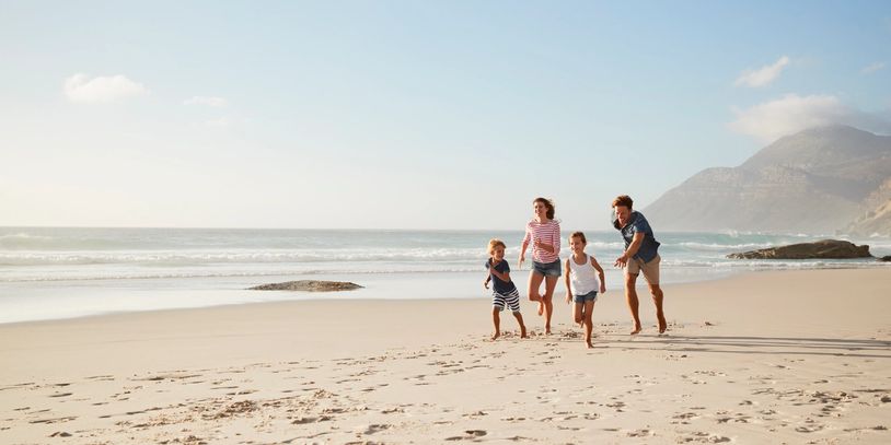 cr=w_814,h_407 (1) Family runs on sunny beach.