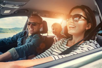 rs=w_400,cg_true Happy family driving on a sunny day.