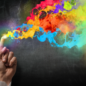 Fingertip releasing colorful paint splashes.