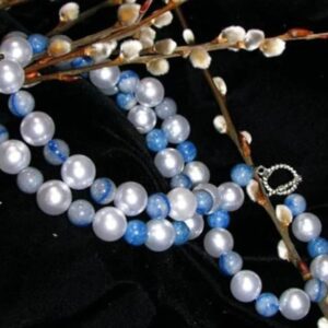 Pearl and blue bead necklace on branches.